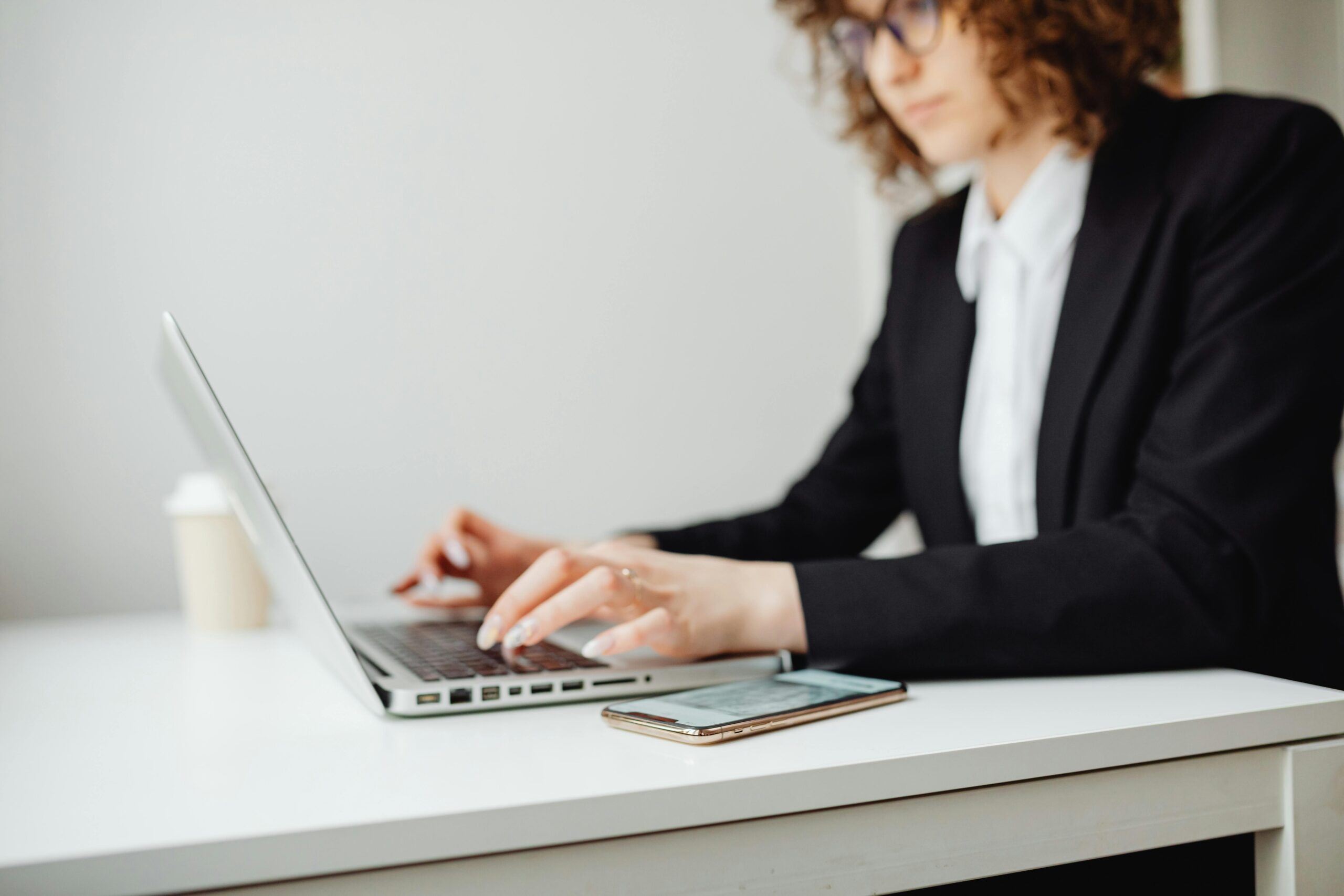 Professional working at a computer, illustrating JPL deposition officer services